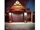 Well-lit detached garage at night featuring wooden design elements and matching exterior lights at 511 N Clark St, Lebanon, IN 46052