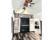 Bright living area showcasing high ceilings, wood flooring, loft with ladder access, and a kitchen view at 511 N Clark St, Lebanon, IN 46052