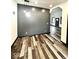Open living space features modern lighting, freshly painted walls, and new wood-look flooring at 511 N Clark St, Lebanon, IN 46052