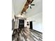 Open living space with vaulted ceiling, modern flooring, ceiling fans, and a stylish loft area at 511 N Clark St, Lebanon, IN 46052