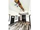 Bright living area showcasing high ceilings, wood flooring, stylish fans, and a loft with ladder access at 511 N Clark St, Lebanon, IN 46052