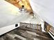 View of the upper loft featuring a wood paneled ceiling with fans and railing at 511 N Clark St, Lebanon, IN 46052
