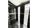 Stylish stand-up shower featuring black tile and glass block windows at 511 N Clark St, Lebanon, IN 46052