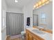 Bathroom with a vanity sink, toilet, and shower with a stylish patterned curtain at 5529 W Mccord Rd, McCordsville, IN 46055