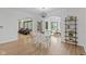 Open concept dining room with wood floors, chandelier, and open access to the living room at 5529 W Mccord Rd, McCordsville, IN 46055