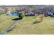 Expansive property featuring a house and pond surrounded by green lawns and mature trees at 563 E Greencastle Rd, Mooresville, IN 46158