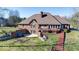 Expansive backyard with a deck, brick patio, mature trees, and well-maintained landscaping at 563 E Greencastle Rd, Mooresville, IN 46158