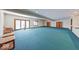 Spacious carpeted basement area with recessed lighting, bookcases, and a sliding glass door to the exterior at 563 E Greencastle Rd, Mooresville, IN 46158
