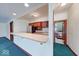 Basement bar area featuring a breakfast bar, stainless steel refrigerator, and a view into the adjacent bathroom at 563 E Greencastle Rd, Mooresville, IN 46158
