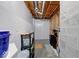 Utility area in unfinished basement with concrete floor, white walls, exposed piping, and storage shelving at 563 E Greencastle Rd, Mooresville, IN 46158