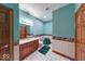 Bathroom with blue walls, patterned wallpaper border, tiled floors, and a wood vanity at 563 E Greencastle Rd, Mooresville, IN 46158
