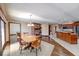 Open dining and kitchen area with wood floors, fireplace, and natural light at 563 E Greencastle Rd, Mooresville, IN 46158