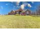 Charming single-story brick home with a well-manicured lawn and beautiful landscaping on a sunny day at 563 E Greencastle Rd, Mooresville, IN 46158