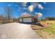 Spacious three-car garage with an asphalt driveway and meticulously maintained landscaping at 563 E Greencastle Rd, Mooresville, IN 46158
