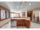 Kitchen with breakfast bar, stainless steel dishwasher, and access to dining area with fireplace at 563 E Greencastle Rd, Mooresville, IN 46158