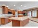 Large kitchen with stainless steel appliances, wood cabinets, and an island with breakfast bar at 563 E Greencastle Rd, Mooresville, IN 46158