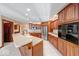 Spacious kitchen with wood cabinets, stainless steel appliances, and an island with breakfast bar at 563 E Greencastle Rd, Mooresville, IN 46158