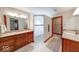 Bright bathroom with double vanities, a walk-in shower and wooden cabinets at 563 E Greencastle Rd, Mooresville, IN 46158