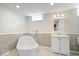This renovated bathroom includes an elegant soaking tub, vanity, and contemporary fixtures at 5884 Kingsley Dr, Indianapolis, IN 46220