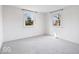 Bright bedroom with neutral carpet and natural light from two windows at 5884 Kingsley Dr, Indianapolis, IN 46220