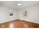 Inviting bedroom with hardwood floors, neutral walls, and natural light from dual windows at 5884 Kingsley Dr, Indianapolis, IN 46220