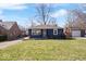 Charming single-story home with a well-maintained lawn and inviting curb appeal on a sunny day at 5884 Kingsley Dr, Indianapolis, IN 46220