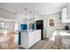 Bright kitchen features white cabinets, granite countertops, stainless steel appliances, and a breakfast bar at 5884 Kingsley Dr, Indianapolis, IN 46220
