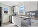 Bright kitchen features white cabinets, granite countertops, stainless steel appliances, and grey subway tile backsplash at 5884 Kingsley Dr, Indianapolis, IN 46220