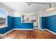 Open-concept living space boasts hardwood floors, natural light, and access to the kitchen at 5884 Kingsley Dr, Indianapolis, IN 46220