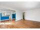 Open-concept living space with hardwood floors and a view into adjacent kitchen at 5884 Kingsley Dr, Indianapolis, IN 46220