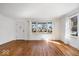 Bright living room with hardwood floors, a large window and a modern door at 5884 Kingsley Dr, Indianapolis, IN 46220