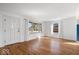 Bright living room with hardwood floors, a large window and a modern door at 5884 Kingsley Dr, Indianapolis, IN 46220