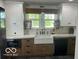 Bright, modern kitchen featuring a farmhouse sink, custom cabinetry, and high-end finishes at 5951 W St Rd 32 W, Anderson, IN 46011