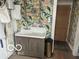 Laundry room featuring a utility sink, floral wallpaper, and storage solutions at 5951 W St Rd 32 W, Anderson, IN 46011