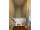 A long hallway leads to a basement door, providing easy access to and from the main living areas at 614 E 11Th St, Indianapolis, IN 46202