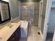 A spacious bathroom featuring a large tub, separate shower, and double vanity at 614 E 11Th St, Indianapolis, IN 46202