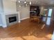 Open concept living space featuring hardwood floors, a stone fireplace, and modern lighting fixtures at 614 E 11Th St, Indianapolis, IN 46202