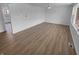 Spacious empty living room with ample natural light and wood-look floors at 6512 Buttonwood Dr, Noblesville, IN 46062