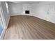 Living room with white brick fireplace, wood floors and filled with natural light at 6512 Buttonwood Dr, Noblesville, IN 46062