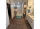 Bathroom featuring tiled shower, a bath tub, a walk-in closet and updated flooring at 6812 Cadwell Cir, Indianapolis, IN 46237
