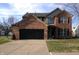 Charming two-story home with brick and vinyl siding, an attached two-car garage, and well-maintained landscaping at 6812 Cadwell Cir, Indianapolis, IN 46237