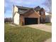 Two-story home with brick and vinyl siding, a two-car garage, and a lush green lawn at 6812 Cadwell Cir, Indianapolis, IN 46237