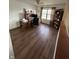 Spacious home office featuring wood floors, a built-in desk, and a bright window with natural light at 6812 Cadwell Cir, Indianapolis, IN 46237