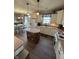 Open kitchen with hardwood floors, white cabinets, stainless appliances and a view into the breakfast nook at 6812 Cadwell Cir, Indianapolis, IN 46237