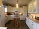 Well-lit kitchen with white cabinets, a center island, and modern appliances at 6812 Cadwell Cir, Indianapolis, IN 46237