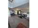 A spacious living room with high ceilings, lots of plants and decor, and a second-floor balcony at 6812 Cadwell Cir, Indianapolis, IN 46237