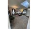 A spacious living room with high ceilings, lots of plants and decor, and large windows at 6812 Cadwell Cir, Indianapolis, IN 46237