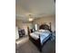 Spacious main bedroom featuring a ceiling fan, carpeted floors, and large windows for natural light at 6812 Cadwell Cir, Indianapolis, IN 46237