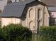 Backyard shed with neutral siding, black roof, and surrounded by greenery at 6812 Cadwell Cir, Indianapolis, IN 46237