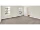 A large bedroom featuring two large windows, neutral paint and carpets at 7152 Jackson Dr, Cumberland, IN 46229
